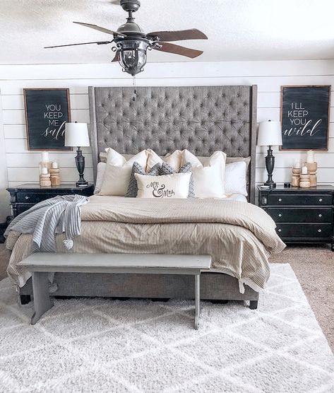 In the master we did a shiplap wall behind the bed and painted the rest of the walls Revere Pewter by Benjamin Moore #shiplap #bedroom #farmhosue #farmhouse Master Bedrooms Decor With High Headboard, Bedroom Ideas With Gray Headboard, Gray Tufted Bedroom Ideas, Grey Tufted Bed Bedroom Ideas, High Headboard Decor Ideas, Gray Bed Frame Bedroom Ideas, High Headboard Bed, High Headboard Beds, Tufted Bedroom