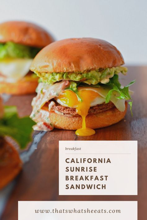 A breakfast sandwich stacked on a brioche bun with drippy egg yolk, avocado, mixed greens, and chicken sausage. Avocado Breakfast Sandwich, Sausage Breakfast Sandwich, California Sunrise, Sunrise Breakfast, Brunch Burger, Breakfast Sandwich Recipes, Avocado Chicken, Breakfast Platter, Breakfast Burger