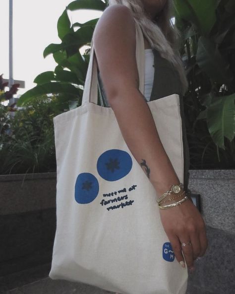 🌿 Exciting News! 🌿 We’re thrilled to announce the launch of our “Meet Me at the Farmers Market” Blueberry Tote! 🍇✨ Continue with your favorite design and elevate your market trips with this fresh, stylish, and eco-friendly bag. Perfect for carrying all your organic goodies! 🥕🥬 grab yours now! 🌟 #FarmersMarket #EcoFriendly #BlueberryTote #SustainableStyle #MarketVibes #HandmadeToteBags, #SustainableFashion, #EcoFriendlyTotes, #HandDrawnDesigns, #ArtisanToteBags, #EthicalFashion, #ReusableSh... Painting Blueberries, Blueberry Painting, Tote Bag Painting, Bag Painting, Painted Tote, Fall 24, Eco Friendly Bags, Handmade Tote, Summer Crafts