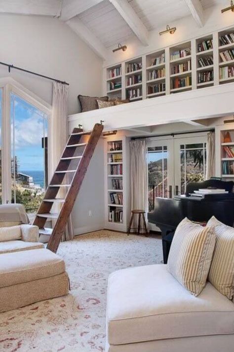 Large home library featuring two-story bookshelves with a ladder for access. House Library With Ladder, Bookshelf In House, Two Level Home Library, Home Library Sunroom, Library Aesthetic In House, Library With Sliding Ladder, House Library Design, In House Library Aesthetic, Beach House Library Room