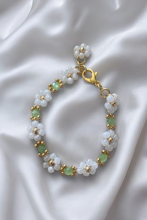 Introducing the exquisite 'Secret Garden' bracelet. This stunning piece of jewellery is designed to complement your outfit with a touch of sophistication. Its beautiful light green color is reminiscent of the natural beauty found in secret gardens. Crafted with attention to detail, this bracelet exudes elegance and style. Its delicate design makes it perfect for both casual and formal occasions, adding a touch of glamour to your look. The 'Secret Garden' e is made from high-quality materials tha Secret Garden Design, Christmas Presents For Women, Green Gem, Green Bracelet, Daisy Bracelet, Bracelets Design, Secret Gardens, Floral Bracelet, Bracelet Design