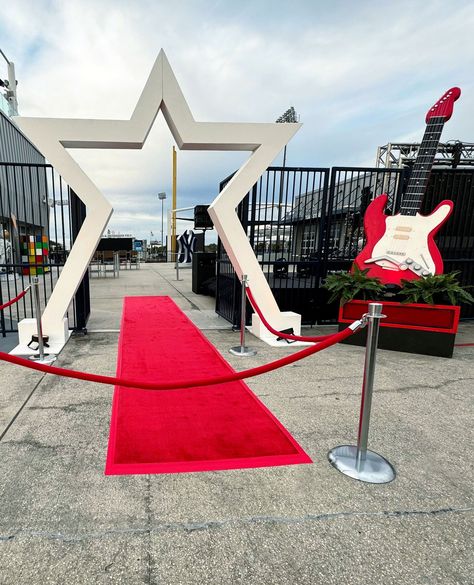 Roll out the red carpet to your rockstar moment! 🌟🎸 Our star studded entrance sets the stage for an unforgettable experience. ✨ #redcarpet #star #electricguitar #guitar #eventdecor #rocknroll #rockstar #retro #vintage #whitestar #whiteandred #customdecor #florida #outdoorevent Rock And Roll Corporate Event, Retro Stage Design, Rockstar Theme Party, Star Entrance, Rockstar Decorations, Concert Decor, Barbie Display, Red Carpet Entrance, Mc Ideas