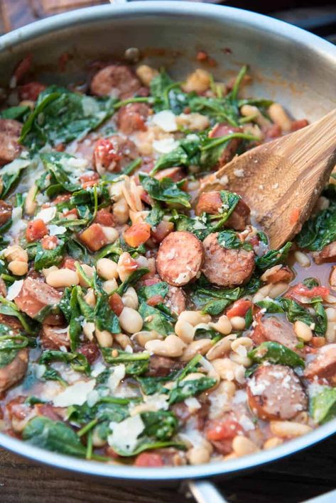 This comforting Skillet Sausage and White Beans with Spinach is on your table in just 30 minutes. Serve with a loaf of crusty bread to soak up the delicious broth for a flavorful, satisfying meal. #30minutemeal #sausage #whitebeans #beans #healthyrecipe #30minutemeals Sausage And White Beans, Sausage Beans, Cherry Pie Bars, Healthy One Pot Meals, Sausage Spinach, Beans And Sausage, Sausage Dishes, Spinach Recipes, Skillet Meals