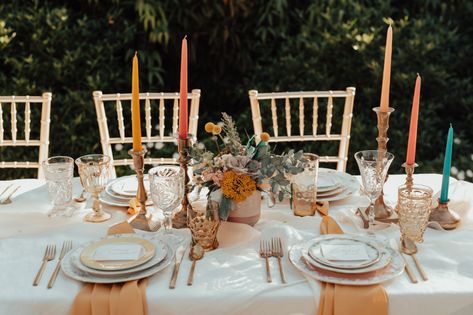 Colorful Spring Head Tablescape from The Copper Quail #Chattanooga #wedding #headtable #tabledecor #weddingdecor #colorfulwedding Colored Candle Sticks Wedding, Brass Wedding Table Decor, Brass Table Setting, Colored Candlesticks Wedding, Glassware Wedding Decor, Colorful Candle Centerpieces, Vintage Candlesticks Wedding, Wedding Vintage Glassware, Wedding Centerpieces Candlesticks