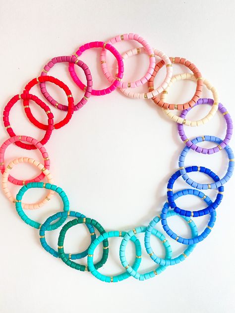 "This listing is for (1) 6mm Heishi Bracelet! This is colorful bracelet and is a fun addition to any bracelet stack. It is completely customizable to your liking. If you would like multiple colors please state so in the \"notes\" section!  You pick the color discs + color of letters + what you want it to say - we deliver exactly that! Please include all of this in the notes section!  This bracelet is made of \"heishi\" beads - made from polymer clay + and a single gold barrel. The gold barrels are plated and are on one side of the bracelet. If you would like to add any personalization, NO problem -- just let me know!   *Disclaimer* as these are naturally made they are prone to fade slightly throughout the life of them.  All bracelets will be made to 7\" unless noted otherwise.  Please be a Disc Bracelet, Polymer Clay Bracelet, Word Bracelet, Clay Bracelet, Beads Bracelet Design, Heishi Beads, Name Bracelet, Colorful Bracelets, Bracelet Stack