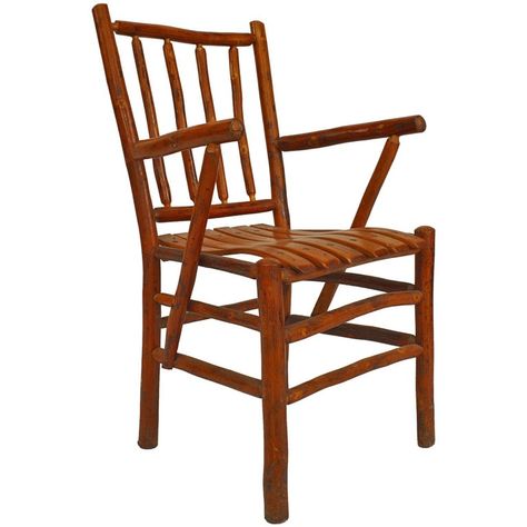 Set of twelve rustic chairs manufactured by the American Old Hickory Company. The set includes two armchairs and ten side chairs, one of which is branded "Martinsville," signifying the city in Indiana in which the Old Hickory Company was located. Each chair features a four spindle back design and a contoured seat above a box form stretcher.Since 1899 Old Hickory Furniture has been handcrafted in Central Indiana using the remarkable hickory sapling and other natural and sustainable resources. Old Rustic Armchair, Old Hickory Furniture, Rustic Bar Stools, Spindle Design, Rustic Stools, Hickory Furniture, Wood Side Chair, Big Chair, Hickory Chair