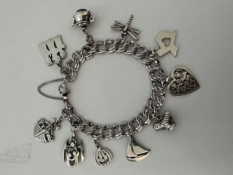 Beautiful 8” Light Double Curb James Avery Sterling Charm Bracelet Retired Teapot, Sailboat, etc.!. All 10 James Avery charms on the bracelet include the following: retired 3 Kings on a temporary jump ring, retired teapot on a temporary jump ring, dragonfly, Heart Texas, retired Love is on a temporary jump ring, retired Southwestern bird/chicken, retired sailboat, Jack-o-lantern on a temporary jump ring, guardian angel w/children on a temporary jump ring, retired Noah’s ark on a temporary jump ring. Rarely/gently worn. I used the temporary jump rings to be able to change out charms when I wanted to. Any James Avery store can easily permanently weld the charms to the bracelet if so desired. 10 total charms. *Will send signature required. James Avery Charm Bracelet, Pandora Bracelet Charms Ideas, James Avery Charms, 3 Kings, Bracelets Collection, Noah S Ark, 2024 Christmas, Bracelet Charms, Pandora Bracelet Charms