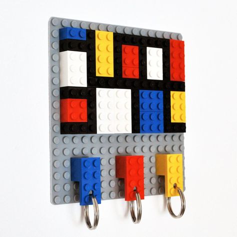 Now your keys will have a special place and will never get lost in the house with this beautiful coloured key hanger that is both practical and a design object, made with Lego Bricks. #homedecor #keyhangers #lego #legoart #mondrian Lego Key Holder, Mondrian Pattern, Lego Jewelry, Mondrian Art, Lego Lovers, Hallway Wall, Lego Pieces, Key Hanger, Heart Shaped Rings