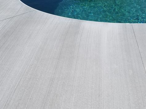 Broom brushed concrete Top Cast Concrete Patio, Brushed Concrete Patio, Polished Concrete Around Pool, Broom Finish Concrete Pool Deck, Broom Finish Concrete, Pool Deck Ideas Inground, Brushed Concrete Pool Deck, Sand Finish Concrete Pool Deck, Exposed Aggregate Concrete Pool