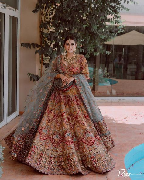 In love with this bride’s stunning red and gold lehenga with blue detailing. The stunning resham and beaded embroidery look absolutely breathtaking and the little blue details took the lehenga up to a notch. Loved the blue dupatta drape which looked flawless paired with a red lehenga. Pc: razzfilmsandphoyography #indianbride #bride #indianwedding #lehenga Blue Bridal Lehenga, Lehenga Look, Red Wedding Lehenga, Latest Bridal Lehenga Designs, Floral Dresses With Sleeves, Gold Lehenga, Indian Bridesmaid Dresses, Latest Bridal Lehenga, Indian Outfits Lehenga