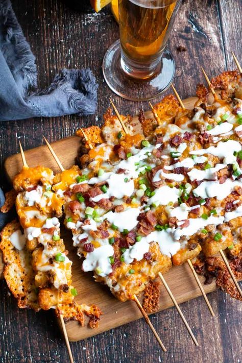 Tater Tot Skewers loaded up with taco spiced ground beef, melted cheese, bacon and drizzled in sour cream. This easy appetizer is so good, you are gonna make this all the time! #cookswithcocktails #appetizer #tatertots #easyappetizer #gameday Tator Tot Skewer, Tostitos Scoops Appetizers, Tater Tot Skewers, Game Day Food Ideas, Tater Tot Appetizers, Cauliflower Tater Tots, Super Bowl Menu, Crunchy Potatoes, Taco Spice