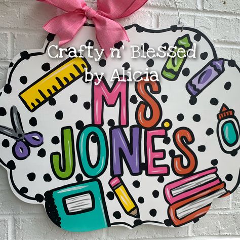 "All our door hangers are designed and hand painted by me! They can be completely customized to YOU! Colors and wording can be changed.  MEASUREMENTS: 22\" WIDE They are hand painted on 1/2\" plywood with acrylic paint and sealed with a clear gloss. Ribbon may vary depending on availability. These are NOT ready to ship/pickup, they are all made to order and you can see our current turnaround time on our main shop announcement page.  We also offer free local pickups. For Georgetown, KY Pickup whe Teacher Plaques Signs, Door Hangers For Teachers, Classroom Door Hangers, Painted Clipboards, Funky Letters, Painted Door Hangers, Painted Banners, Georgetown Ky, Teacher Door Hanger