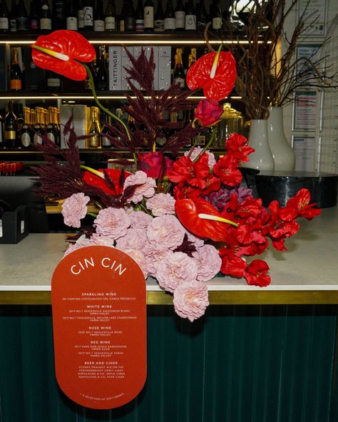 Cin Cin 🥂 The most beautiful bar florals with signage from @signed_byg perfectly tying together all the elements. We can't get enough of this colour palette 😍 Venue @rockartevents Signage & table stationary @signed_byg #florals #weddingflowers #weddinginspiration #barflorals #drinkmenu #melbourneweddings #weddingideas Moody Red Florals, Moody Florals Wedding, Pink And Red Wedding Flowers, Bar Floral Arrangement, Table Stationary, Red Pink Wedding, Bar Florals, Wedding Reception Bar, Retro Vegas