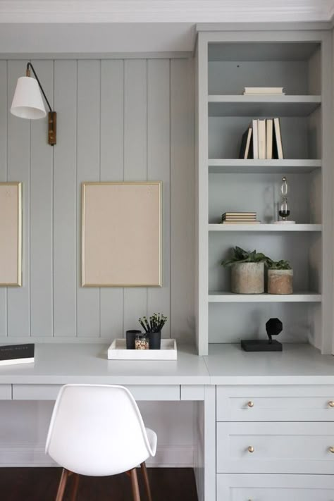 Vertical shiplap and blue-gray cabinets with brass hardware make for a beautiful modern home office. Coastal Home Office, Blue Home Offices, Coastal Office, Office Built Ins, Cool Office Space, Office Nook, Study Nook, Built In Desk, Home Office Space