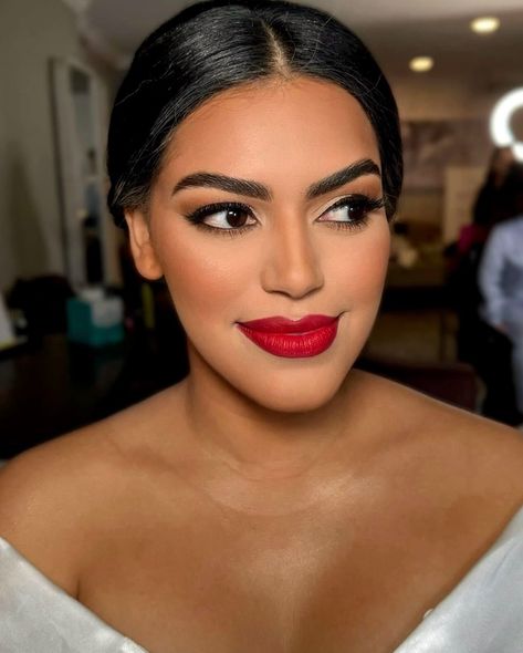 Should brides wear red lipstick on their wedding day? 💄 Absolutely! Here’s why: 👇🏼 ✨ Timeless Elegance: Red lipstick adds a touch of timeless elegance, creating a classic and sophisticated look that shines in wedding photos. ✨Confidence Booster: The boldness of red lipstick can boost your confidence, making you feel empowered and glamorous on your special day. ✨Striking Contrast: Red lipstick creates a striking contrast against a white wedding dress, adding a pop of color that highlights ... Indian Red Lipstick Makeup, Formal Makeup With Red Lipstick, Bridal Lip Color, Makeup For A Red Dress, Radiant Skin Glow, Bridal Hmu, Red Lipstick Makeup Looks, 21st Ideas, Skincare Favorites