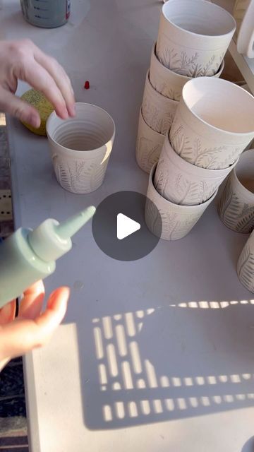 EG Designs on Instagram: "Glazing fern cups. These cups are small and perfect and take some time!  From carving with three different carvers to keep them lively and organic, to glazing those carvings green, these just take time.   But I think they are worth it- what do you think?" How To Carve Pottery, Pottery Underglaze Carving, Glazing Carved Pottery, Clay Cup Ideas, Underglaze On Greenware, Underglaze Mug, Underglaze Transfer Mug, Clay Cup, Glazing Techniques