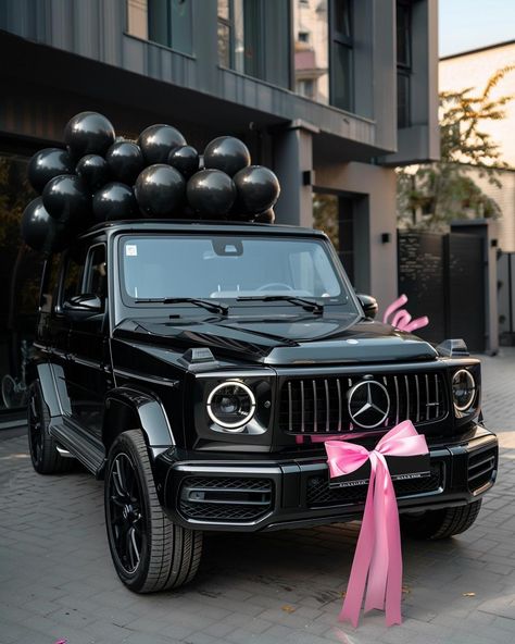 Embrace the elegance of celebration with this breathtaking scene featuring a luxurious black Mercedes-Benz G-Class. Adorned with a charming pink bow and surrounded by sleek black balloons, it's a vision of sophistication. ✨Don't forget to save and follow for more captivating visuals!👉 #LuxuryLifestyle #CelebrationVibes #MercedesBenzGClass #BlackAndPinkElegance #CarGoals #Aesthetic #AIImage Mercedes Benz Luxury Cars, G Wagon Vision Board, All Black Cars Luxury, G Wagon With Bow, Pink G Class Mercedes, Mercedes Benz Vision Board, Black G Wagon Pink Interior, New Car Aesthetic Vision Board, Cars For Vision Board