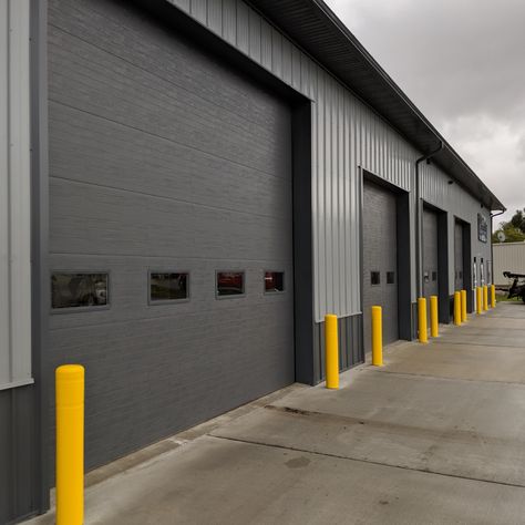 When Midwest Repair & Towing needed an office and shop for their operations they partnered with Walters Buildings for a highly functional and efficient building. 

This building is 104' long by 48' wide with 4 work bays, an office and waiting room for customers. The project featured our gray panels with charcoal wainscot and trim. The interior is lined and insulated so they can work in comfort year round. Steel Office Building, Factory Facade Design, Factory Facade, Kingston House, Truck Garage, Warehouse Layout, Aluminum Garage, Modern Warehouse, Metal Building Designs