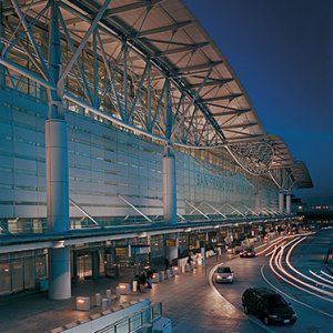 As the centerpiece of a $2.6 billion expansion at the San Francisco International Airport, this iconic structure created a powerful identity for both the airport and the City of San Francisco. It also represented a watershed moment in the integration of structural and architectural design.  The terminal is topped with a graceful roof whose wing-like form directly expresses the structural diagram of its bending forces. A series of double-cantilevered trusses linked by bowstring trusses support th Airport Architecture, San Francisco Airport, Monumental Architecture, San Francisco International Airport, Airport Aesthetic, Airport Terminal, Airport Design, Airports Terminal, House Deco