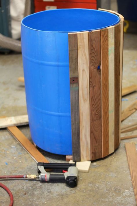 Reclaimed wood transforms a blue barrel (or ugly plastic pot) into a beautiful planter. Drum Planters, Kolam Koi, Planters Garden, 55 Gallon Drum, نباتات منزلية, Barrel Planter, 55 Gallon, Front Porch Ideas For Mobile Homes, Rain Barrel