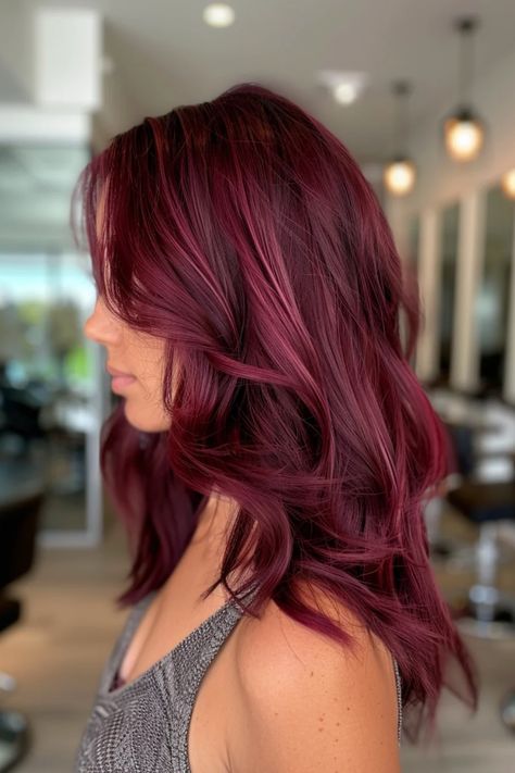 Woman with deep burgundy, wavy hair in a salon setting. Burgundy Red Hair Balayage, Wine Red Hair Highlights, Cherry Coke Aesthetic, Small Highlights In Brown Hair, Hair Color Ideas With Highlights, Red Velvet Hair Color, Burgundy Hairstyles, Highlights In Brown Hair, Dark Cherry Hair