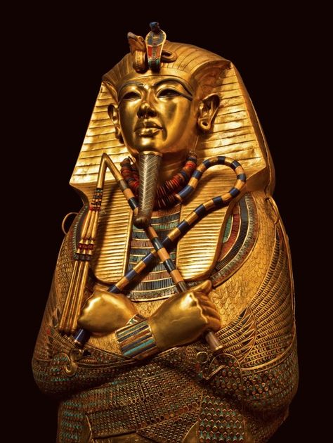 This coffin of solid gold is covered with incised decorations and inscriptions inside and outside, with the names and epitaph of the deceased king and protective texts. It is inlaid with semiprecious stones and colored glass. The coffin’s shape is that of Osiris holding the sacred insignia, the heka scepter and the flail. The vulture and the uraeus, or rearing cobra, protect his forehead. The divine beard is made of gold inlaid with blue glass. Deities of Upper and Lower Egypt protect. King Tut Tomb, The Boy King, Egypt Museum, Amenhotep Iii, Ancient Egypt Art, Egypt History, Valley Of The Kings, Egypt Art, Egyptian Mythology