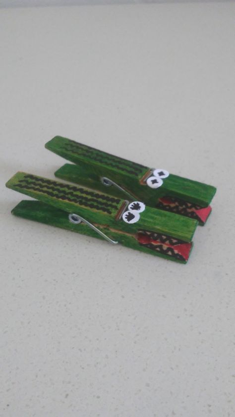 Green, red, and black markers help you transform clothespins into cute little alligators. The eyes are made using white paper and a hole punch. They are perfect as simple toys the kids can make themselves or to use as decorative clips. Alligator Crafts, Simple Toys, Spring Crafts For Kids, Hole Puncher, Clothes Pin Crafts, Kids' Crafts, Green Outfit, Toy Craft, Clothes Crafts