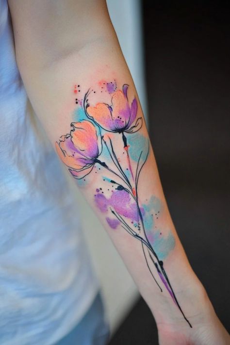 Watercolor-style tattoo of colorful flowers on a person's forearm. Tattoo Ideas Colorful, Watercolor Tattoo Design, Watercolor Flower Tattoo, Watercolor Phoenix Tattoo, Watercolor Heart Tattoos, Watercolor Wolf Tattoo, Luna Moth Tattoo, Watercolor Tattoo Tree, Watercolor Tattoo Ideas