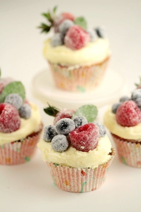 These Frosted Berry Cupcakes with an Orange Mascarpone Buttercream feature a fluffy orange cake topped with a luscious frosting, and sugared fruit. They are a beautiful cupcake full of bright flavours. Fruit On Cupcakes, Cupcakes Decorated With Fruit, Fruit Topped Cupcakes, Cupcakes With Fruit On Top, Buttercream Desserts, Mascarpone Buttercream, Sugared Berries, Sugared Fruit, Berry Cupcakes