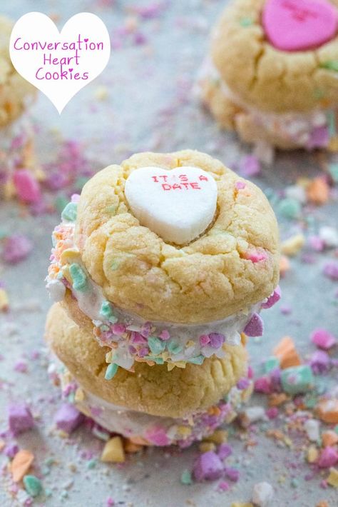 Conversation Heart Cookies with Marshmallow Fluff -- Put those conversation hearts to good use this Valentine's Day by baking Conversation Heart Cookies. Marshmallow fluff is sandwiched between two colorful candy confetti-packed sugar cookies and will instantly have you falling in love | wearenotmartha.com Cookies With Marshmallow Fluff, Cookies Marshmallow, Heart Cookies Recipe, Homemade Marshmallow Fluff, Valentines Snacks, Marshmallow Cookies, Conversation Heart, Valentines Day Desserts, Valentines Day Food