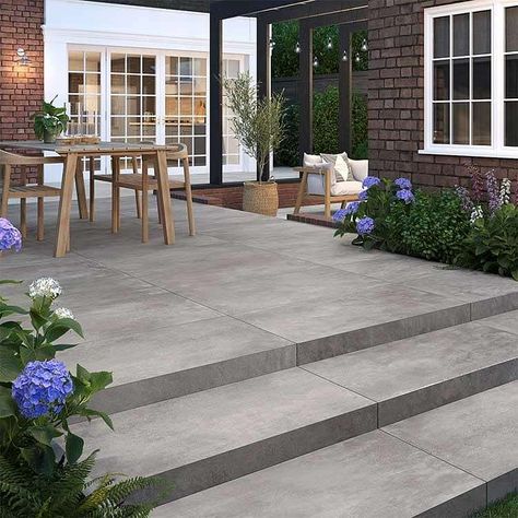 Berkley Anthracite brings a serene industrial vibe to the outdoors, in a fashionable dark shade that replicates the look of concrete.  These outdoor porcelain tiles are easy to install, hardwearing and durable, and will create a sophisticated, trendy look to your exterior space.  Also available in a 900x900mm size. Exterior Tiles Floors, Outside Flooring Ideas, Outdoor Paver Patio Ideas, Outdoor Patio Tile Ideas, Patio Tiles Outdoor Flooring, Garden Patio Designs, Patio Door Window Treatments, Porcelain Patio, Outdoor Floor Tiles