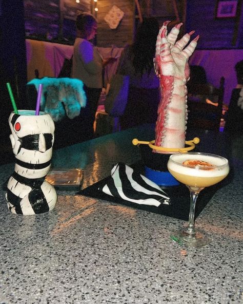 calling all beetlejuice lovers! 👻✨ @hiddenbarnashville has brought the iconic world of beetlejuice to life with killer themed drinks and spooky decor that’ll have you saying, ‘it’s showtime!’ 🍸💀 make sure to swing by before the spooky season ends. trust me, this is one haunt you won’t want to miss! 🎃🎥 Beetlejuice Shrimp Hand, Beetlejuice Halloween, Themed Drinks, Shrimp Cocktail, Spooky Decor, Beetlejuice, Spooky Season, To Miss, Bring It On