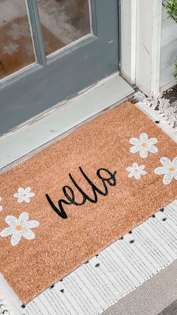 Nikki Muhilly | Realtor ® on Instagram: "The weather isn’t cooperating but that’s not stopping me from bringing some spring decor to the porch. @nickeldesigns has did it again with their custom doormat and layering rug! I’m obsessed with the daisies on this doormat. I love layering my doormats with rugs and @nickeldesigns has such a great variety! They even take custom orders! You can use code HEYSPRING for 15% off! Are you doing a spring decor refresh? Tell me below! #gifted #nickeldesigns" Spring Doormat Diy, Spring Door Mat Ideas, Spring Doormat Ideas, Diy Mats Doormats, Cute Door Mat, Doormat Painting, Doormat Aesthetic, Diy Rug Painting, Door Matts