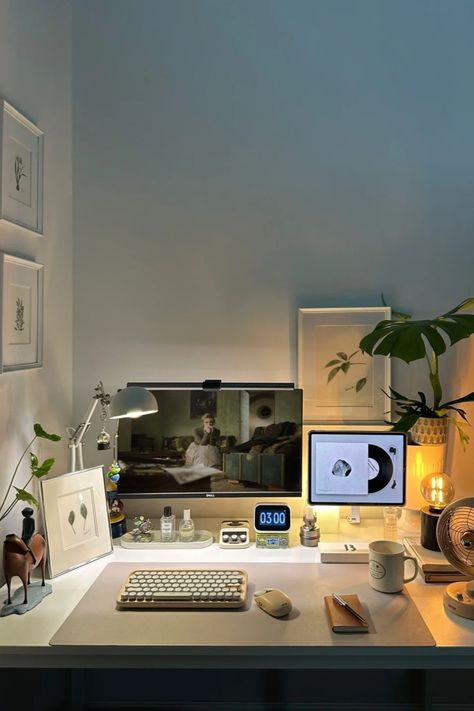 A minimalist home office setup with a dual monitor, mechanical keyboard, ambient lighting, and small decor like plants and art. Ideal for productive work sessions. Minimal Home Office Setup, Minimal Desk Lamp, Minimalist Desk Setup, Minimal Home Office, Desk Arrangement, Home Office Designs, Desk Arrangements, Minimal Desk, Minimalist Home Office