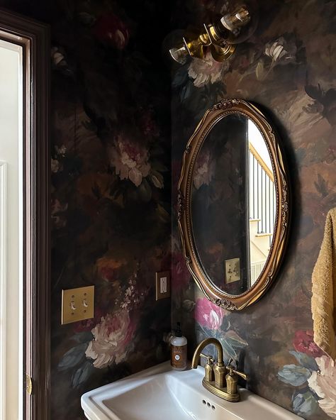 I realized recently I haven’t shared the powder room in a long while, so here she is! You know I love going bold and moody wherever I can, and I think small spaces are the perfect opportunity to do so. This large scale floral wallpaper by @woodchipandmagnolia already felt so bold, but I went a step further and married it with @farrowandball London Clay in full gloss on the trim + door. The combo is a floral chocolate delight! 🌸🍫✨ You can find sources for the powder room here: https://liketk.... Eccentric Powder Room, Moody Half Bath, London Clay, Moody Powder Room, Rachel House, Collected Home, Historic Renovation, Basement House, Large Scale Floral