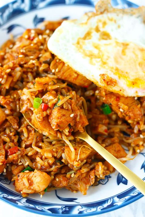 Kimchi Fried Rice with Chicken is easy to make in one wok and full of BIG and BOLD flavors! This Korean fried rice is made with savory tender chicken pieces, tangy kimchi, fragrant aromatics, veggies and the most delicious gochujang infused spicy, smoky, and tangy sauce with a hint of sweetness. Ready in 30 minutes, it’s the perfect tasty meal for busy weeknights! #kimchi #kimchifriedrice #highproteinmeals #koreanfood #korean #healthy #dinner #mealprep #maindish #friedrice | That Spicy Chick Kimchi Fried Rice With Chicken, Chicken Kimchi Fried Rice, Chicken And Kimchi Recipes, Korean Fried Rice, Rice With Chicken, Brine Chicken, Chicken Rice Bowls, Kimchi Fried Rice, Rice Dinner