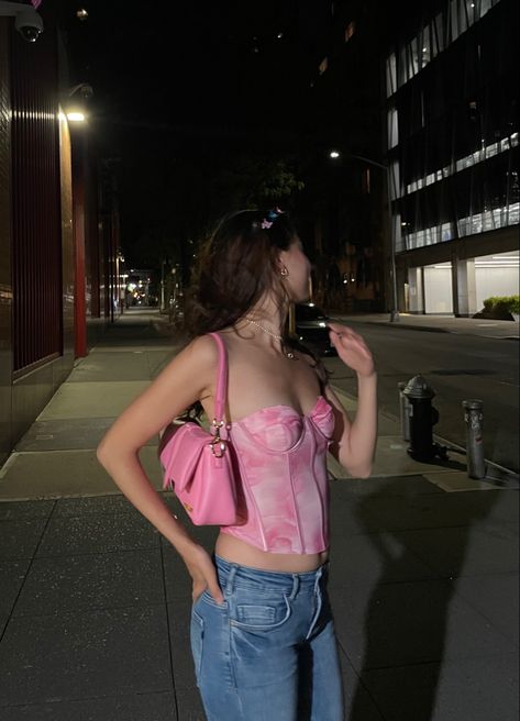 Girl looking away on a dimly lit street wearing a rosy pink corset, pink puffy bag, and low rise denim. Pink Corset Top Outfit, Pink Corset Outfit, Corset Top Outfit, Pink Corset, Corset Outfit, Movies Outfit, Barbie Movies, Corset Top, Denim Outfit