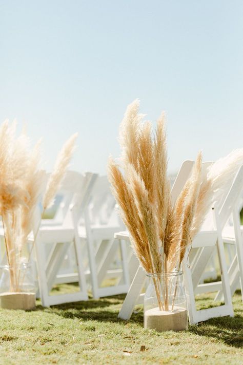 Pampas Grass And Palm Leaves Wedding, Simple Beach Wedding Aisle, Beach Wedding Pampas Decor, Pampas Grass Seating Chart, Beach Pampas Grass Wedding, Pampas Grass Chair Decor Wedding, Modern Boho Beach Wedding, Beach Wedding Arch Ideas Simple, Beach Wedding Aisle Decor Walkways