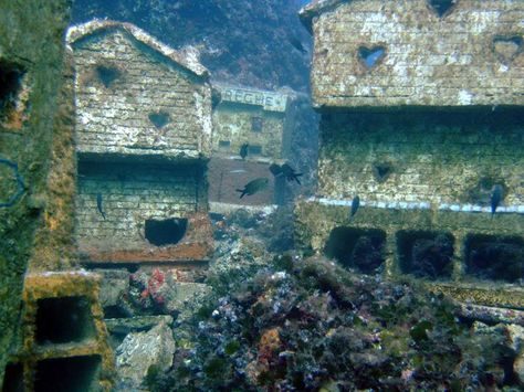 At 30 meters below sea level near a lighthouse called La Fourmigue, off the Cap d’Antibes, lies the remains of a 1000m² underwater miniature French town complete with houses and buildings up to a meter high, a church, town square, an amphitheatre and even a lawyer’s office. Abandoned Underwater, 60s Film, Underwater Film, Underwater Ruins, Underwater Hotel, Underwater Sculpture, French Town, Sunken City, Abandoned Cities