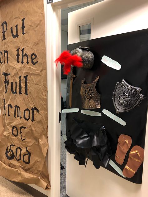 WOW! Now this idea really sums up the theme! Use brown paper and write out the words Put on the Full Armor of God. Take the paper and crinkle it so it will have an "old" look and feel. Collect items that represent the Belt of Truth, Helmet of Salvation, Shoes of Peace, Shield of Faith, and Breastplate of Justice. Use a hot glue gun to secure these items in place then attach it to a door using duct tape or other safe adhesive approved by your church leadership. Armor Of God Belt Of Truth Craft, Armor Of God Vbs Decorations Diy, Armor Of God Vbs Decorations, Sunday School Themes, Shoes Of Peace, The Belt Of Truth, Kingdom Vbs, Church Trunk, Peace Crafts