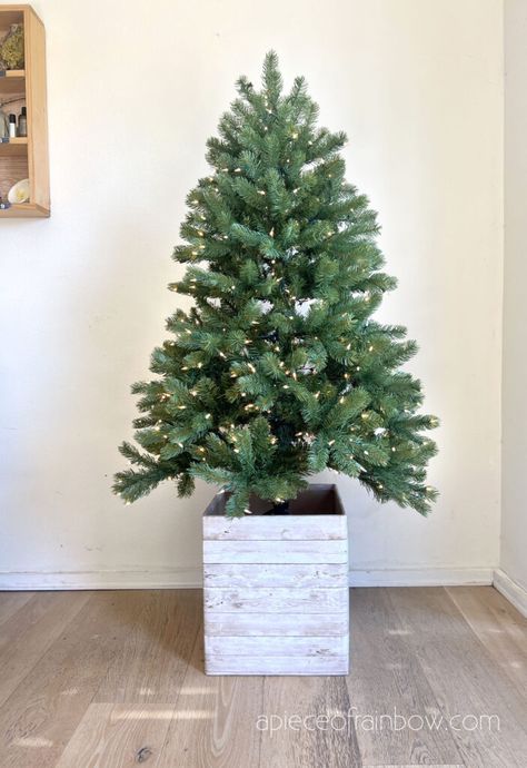 Easy $1 DIY elevated Christmas tree box stand Box Christmas Tree Stand, Elevated Tree Stand, Small Table Christmas Tree, Christmas Tree Boxes Wooden Diy, Making Christmas Tree Taller, How To Make Your Christmas Tree Taller, Elevated Christmas Tree, Christmas Tree Base Ideas Diy, Christmas Tree Riser