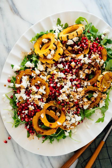 This stunning vegetarian salad features roasted delicata squash, pomegranate, arugula, pepitas and feta tossed in maple balsamic vinaigrette. It's perfect for Thanksgiving, Christmas, or weekend feasts. #delicatasquash #salad #fall #winter #thanksgiving #cookieandkate Delicata Squash Salad, Maple Balsamic Vinaigrette, Vegetarian Dinner Ideas, Roasted Delicata Squash, Cookie And Kate, Maple Balsamic, Pomegranate Salad, Squash Salad, Delicata Squash