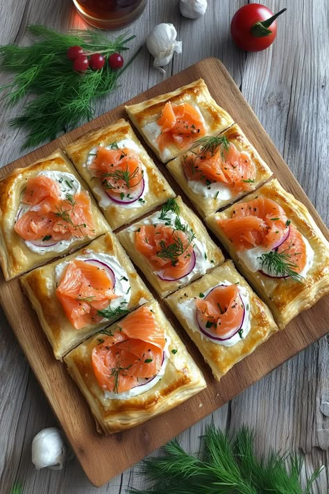 Create these Christmas Smoked Salmon Puff Pastry Pizza Squares for your next holiday party. Buttery puff pastry, creamy cheese, and savory smoked salmon make the perfect festive appetizer. Quick, elegant, and absolutely delicious. Save this recipe and wow your guests this holiday season! Smoked Salmon Puff Pastry Recipes, Puff Pastry Twists Savory, Puffy Pastry Appetizers, Savory Puff Pastry Recipes Appetizers, Breakfast Puff Pastry Recipes Savory, Puff Pastry Tart Savory, Smoked Salmon Puff Pastry, Salmon Puff Pastry, Pizza Squares