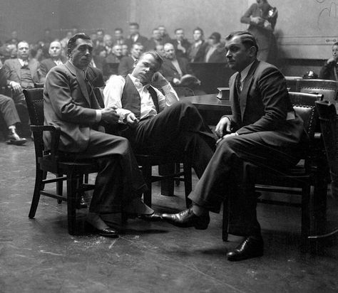 John Dillinger was a bank robber during the 1930s and named "Public Enemy No.1." Here Dillinger (center) is handcuffed to Sheriff R. M. Pierce during a hearing in 1934. Dillinger was charged with killing police officer W. O' Malley during a bank robbery in East Chicago Indiana. Crown Point Indiana, John Dillinger, Deputy Sheriff, Wise Guys, Bank Robber, Bank Robbery, Sheriff Deputy, Al Capone, County Jail