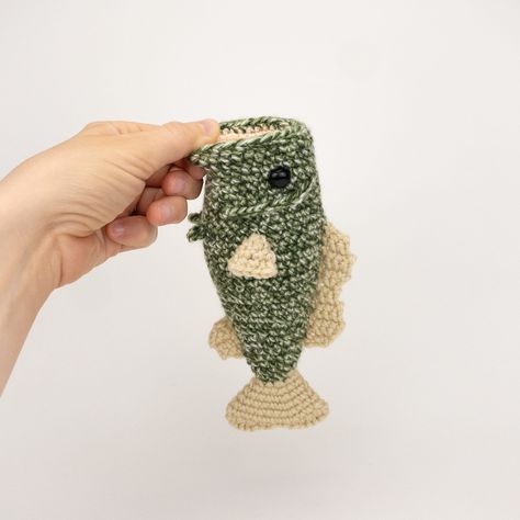 PLEASE NOTE: THIS PURCHASE IS ONLY FOR A DIGITAL CROCHET PATTERN, NOT THE FINISHED ANIMAL Create your own largemouth bass in under 2 hours! This easy-to-follow pattern includes detailed instructions, pictures, and video tips on how to crochet and assemble all the parts to make this bass.  This pattern uses the following stitches: chain, single crochet, double crochet, half double crochet, and the slip stitch Materials You Will Need     * Crochet hook size: 3.75mm     * #4 medium worsted weight yarn*: speckled or solid green (for the body), light peach/pink (for the mouth), and tan (for the fins)     * Yarn needle     * One pair of 12 mm safety eyes     * Polyester fiber fill stuffing Final measurement for the finished bass is 7.75 inches (or 20 cm) long. *Guess what? This listing also incl Crochet Trout Fish, Bass Crochet Pattern, Crochet Bass Fish Pattern Free, Crochet Presents For Men, Crochet Bass Fish, Crochet Fish Pattern Free, Fish Crochet Pattern, Crocheted Fish, Fish Crochet