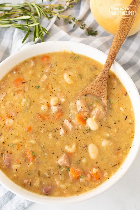 Ham and Bean Soup will warm your soul and belly this season. Hearty chunks of ham, buttery beans and veggies in a savory broth makes this a comforting winter supper. #soup #ham #leftoverham #beans #heartysoup #hamandbeansoup #beansoup #hamsoup #wintersoup #fallsoup #healthysoup #leftovers #hotsoup #navybeans #hambone #souprecipes #greatnorthernbeans #whitebeansoup Recipes With Ham Broth, White Bean Ham Soup, Ham Bone Soup Recipes, Soup Ham, White Beans And Ham, Healthy Ham, Ham Soup Recipes, Ham Bone Soup, Ham And Bean