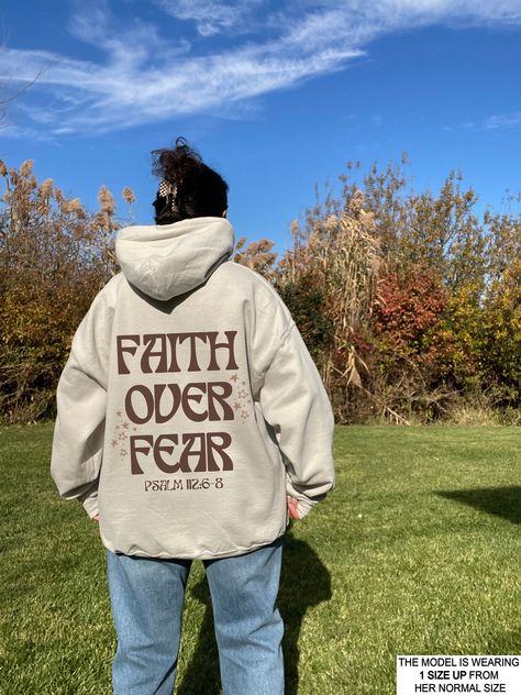 We are loving our latest Christian Hoodie! It's giving total Christian Aesthetic Trendy Vibes! We love that this is a unisex style & can work great for a men's Christian Hoodie & Is a great gift! See the rest of our christian collection here! - https://www.etsy.com/shop/StudioAMARIE?ref=shop-header-name&listing_id=948312516§ion_id=44846198 This hoodie is so cozy that you won't want to take off! Cute, comfortable and trendy -- a necessity for any aesthetic clothing collection! The material is the Brown Hoodie Aesthetic, Christian Style Outfits, Christian Hoodie Design Ideas, Hoodies Aesthetic Christian, Christian Graffiti, Christen Sweatshirts, All We Need Is Jesus Hoodie, Oversized Christian Hoodie, Church Merch