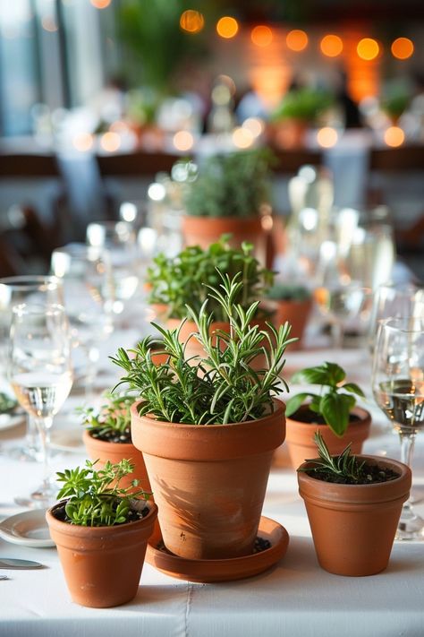 Bring a fresh twist to your wedding tables with our DIY guide on creating eco-friendly centerpieces! 🌿💐 Perfect for the green-hearted couple, these potted herbs add a natural scent and charm to your decor. Plus, guests can take home a piece of your special day. #EcoWedding #DIYCenterpiece #HerbGarden #SustainableLiving #WeddingIdeas #GreenWedding #WeddingDecor #EcoChic Plant Themed Wedding Wedding Table Decor, Restaurant Table Centerpiece Ideas, Wedding Decor Potted Plants, Potted Herbs Tablescape, Clay Pot Wedding Decor, Herbs As Centerpieces, Botanical Table Decor, Fresh Herb Centerpieces, Eco Friendly Centerpieces