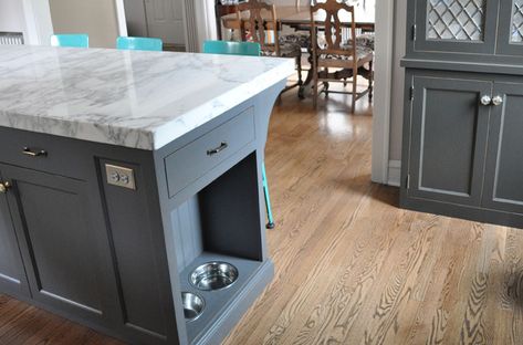 Stylish and thoughtful kitchen design charcoal gray kitchen cabinets with nickel hardware, and Lyon Stool with Steel Back in turquoise blue paired with a gray kitchen island with carrara marble countertops and built in pet food bowls. Pet Food Cabinet, Charcoal Gray Kitchen Cabinets, Island Storage, Kitchen Island Storage, Серая Кухня, Grey Kitchen Island, White Kitchen Island, Dog Food Bowls, Grey Kitchen Cabinets