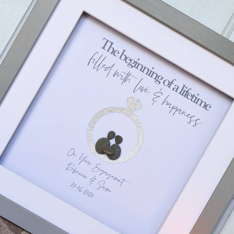 ❤️ Personalised pebble art is the perfect gift to celebrate a new engagement❤️The two pebble people sit within a sparkly engagement ring which captures the special date and names forever. . ❤️ Original and handmade artwork is the ultimate gift for any occasion and when personalised, the artwork becomes just as unique as its owner. You can personalise by choosing your combination of pebble people (adults, children and even pets) and your own personalised message to appear under the couple. ❤️ The Sparkly Engagement Ring, Pebble People, Stone Pictures Pebble Art, Box Frame Art, Anniversary Frame, Garden Artwork, Stone Pictures, Collage Art Mixed Media, Wedding Gift Ideas